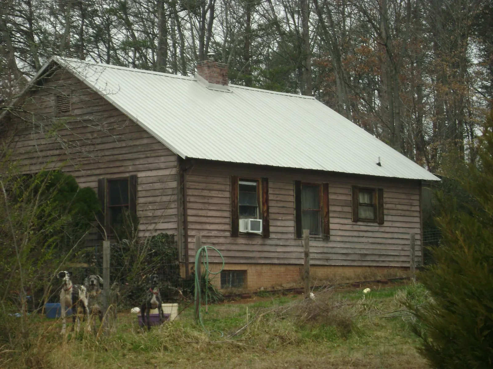 White metal roof on an old wood sided farmhouse, from a Metal Roof Installation job in Knoxville